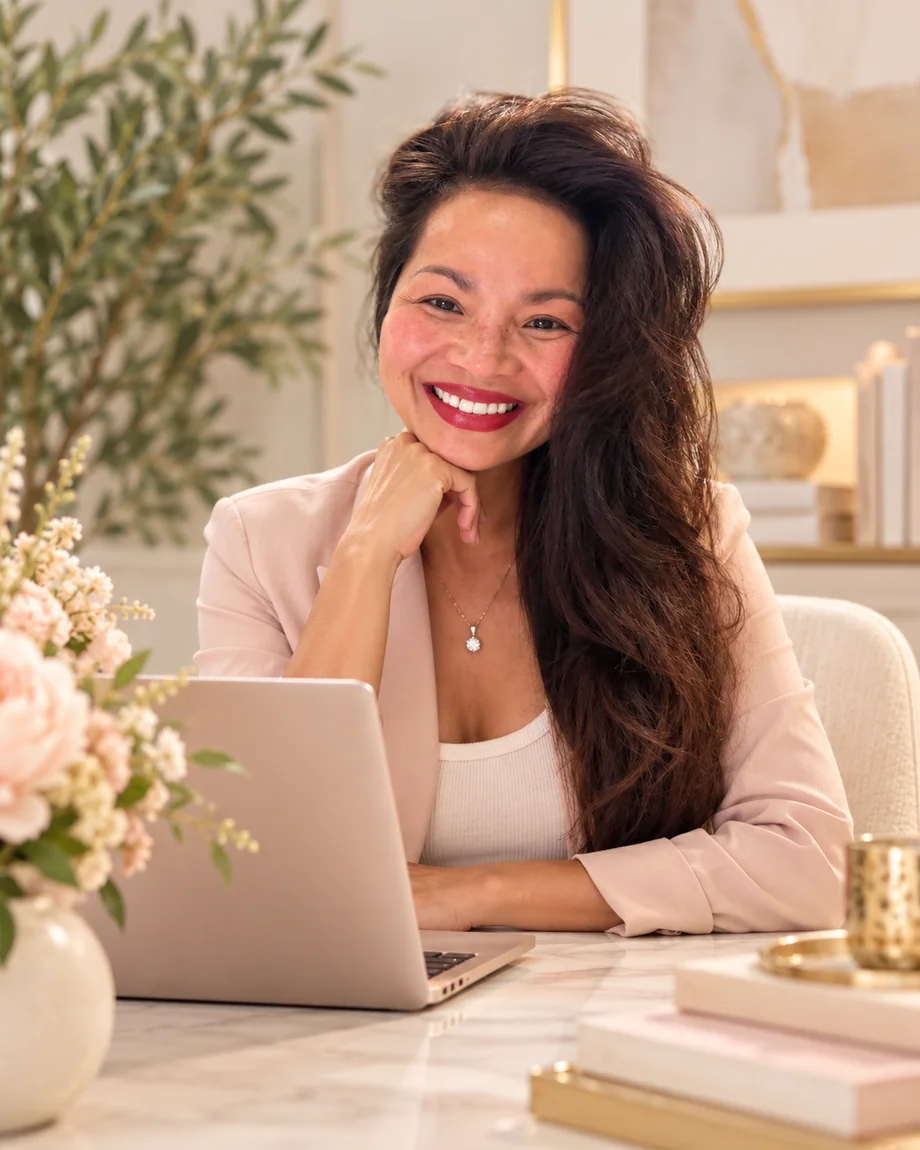 Editorial portrait of a woman working on a laptop in an elegant design studio.